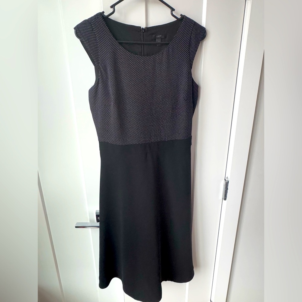 Small Tall (ST). Black and white polka dot top, black aline skirt.